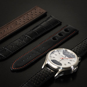 A watch photographed alongside the collection of watch straps from Atelier Jalaper